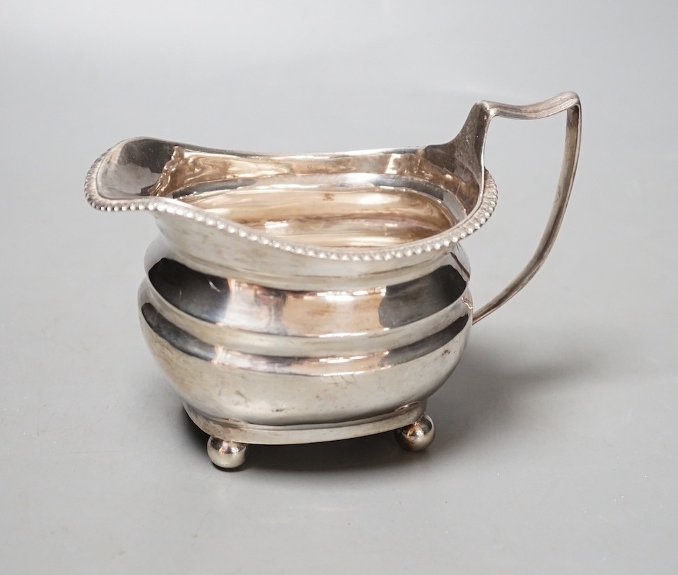 A George III silver cream jug, marks rubbed, 154 grams.